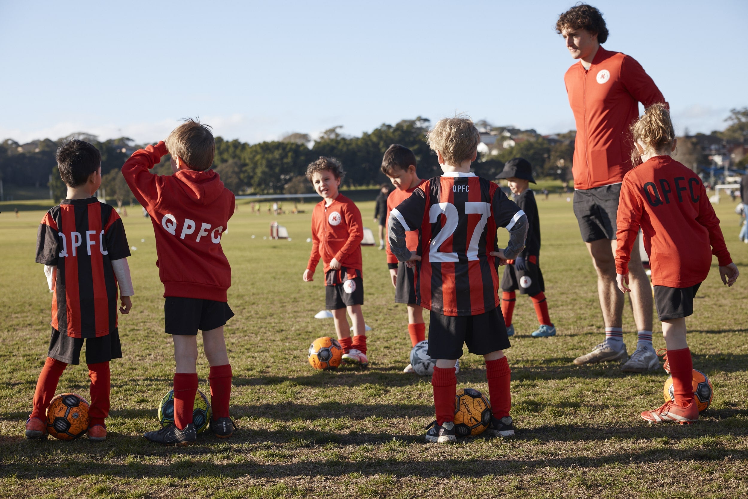 QPFC kids on soccer field with coach